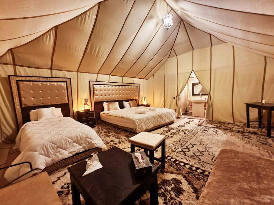 1 night Camel Trek in Merzouga Desert - Inside the desert camp: private tent, bathroom setup, and Berber music