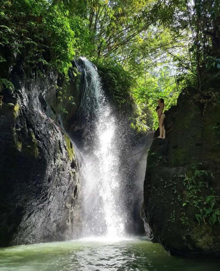 Ubud: Trekking Through Rivers & Forests to Three Waterfalls - Water jumping and the natural water slide